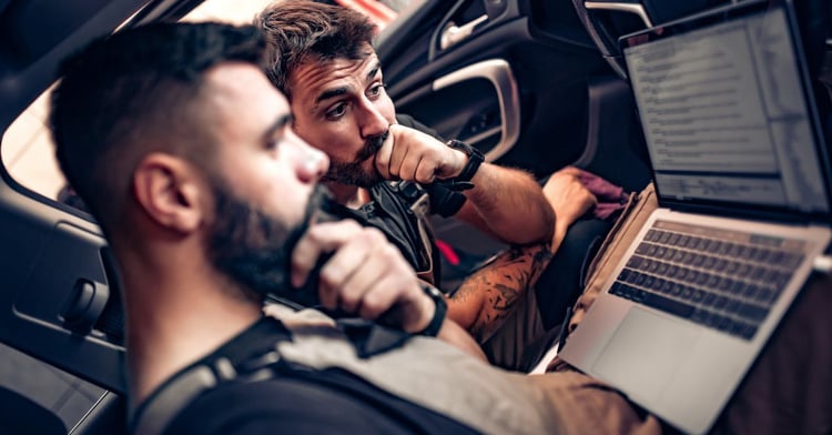 Two employees improving their repair shop's SEO online
