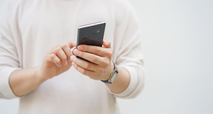 Masculine hands holding a cellphone 
