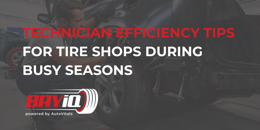 tire shop technician working on vehicle 